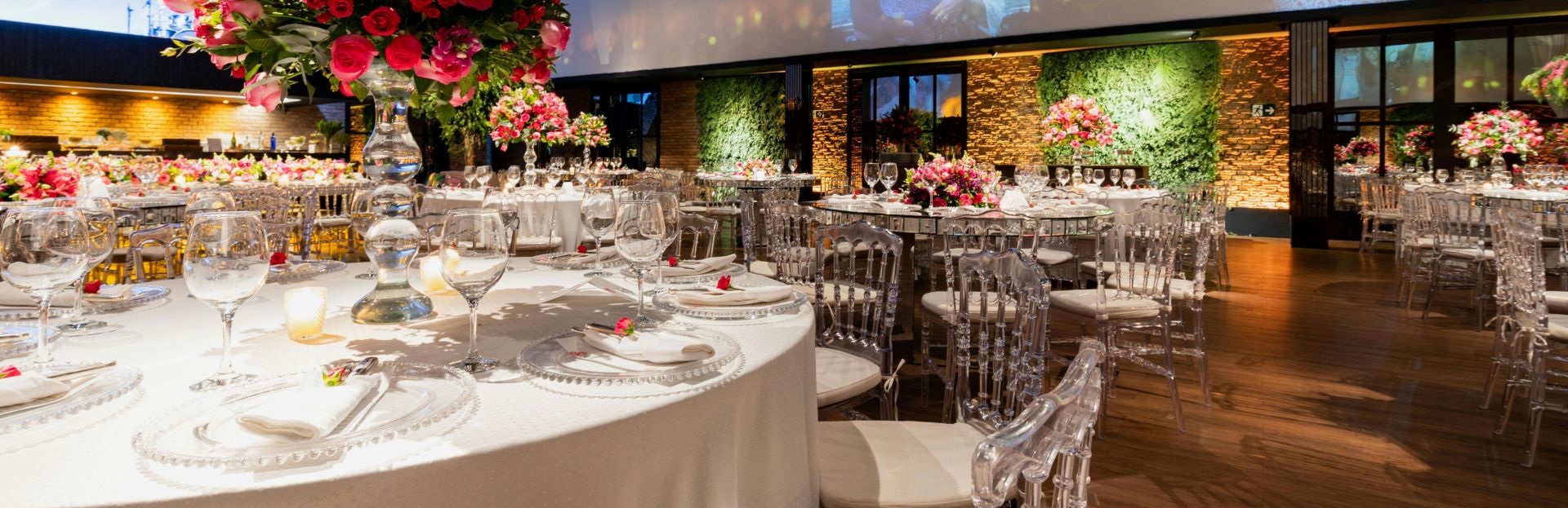 Stunning wedding reception setup with elegant floral centerpieces and ambient lighting.